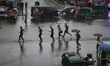 Residents make their way during the heavy rainfall in Dhaka, Bangladesh, on May 31, 2025. 