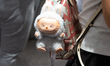 A woman with a Labubu doll on her backpack is at a Pop Mart store in Shanghai, China, on J...