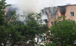 A fire rages in an apartment block damaged by a massive overnight Russian strike in Kharki...