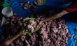 People prepare meat to distribute to the less fortunate during the celebration of Eid al-A...