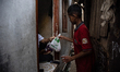 People distribute qurbani meat in a densely populated area in Jakarta, Indonesia, on June...