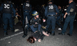 Police arrest a demonstrator during a rally to show support for activists aboard a boat st...