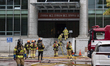 Firefighters reassemble their equipment before resuming firefighting operations at the int...