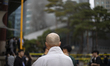 Buddhist monks watch the scene of a fire with concern at the Korean Buddhist History and C...