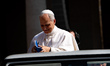 Pope Leo XIV signs a book of a faithful as he arrives in St. Peter's Square for his weekly...