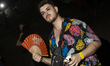 A man holds a fan at the EXIT music festival in Petrovaradin Fortress, Novi Sad, Serbia, o...