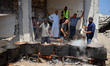Palestinian chefs who are members of a charity kitchen cook food for displaced people and...