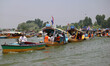 Workers of the Jammu and Kashmir Apni Party participate in a boat rally at Dal Lake in Sri...