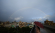 A rainbow shines on the horizon following a brief rainfall in Lalitpur, Nepal, on June 20,...