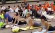 People participate in a yoga mass class to celebrate the annual International Yoga Day at...