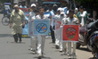 Indian school children, along with others, take part in an awareness rally against the Int...