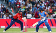 Number 40, Amy Jones of England, unsuccessfully attempts to stump number 23, Harmanpreet K...