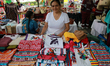 A woman attends her stand of various traditional Oaxacan costumes during the Guelaguetza T...