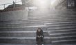 A young Iranian woman uses her cell phone while sitting at Adrenaline Park in northwestern...