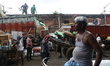 Labourers load sacks of consumer goods onto supply trucks at a wholesale market in Kolkata...