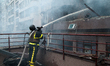 A firefighter uses water to extinguish a fire in an apartment in the Shevchenkivskyi distr...