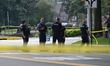 Members of the crime scene unit work at the scene after a vehicle strikes multiple childre...