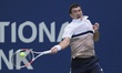 Sebastian Ofner of Australia plays a forehand against Reilly Opelka of the United States d...