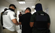 Federal officers detain a man at the Immigration court office areas at the Jakob Javits Fe...