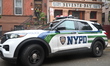 NYPD police officers work at the crime scene and prevent entry to the building where the s...
