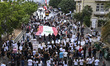 Lebanese demonstrators carry portraits of the victims of the catastrophic port explosion i...