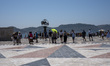 A general view shows people walking on the compass rose and the world map during the heat...