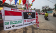 A pirate flag from the Japanese anime, One Piece, is displayed at a stall selling Indonesi...