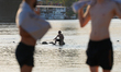 People are seen walking in the middle of the Vistula river in Warsaw, Poland on 14 August,...