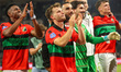 NEC players celebrate with the fans during the match between Heracles and NEC at the Asito...