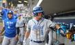 Hartford Yard Goats player Charlie Condon, number 8, receives congratulations in the dugou...