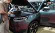 Visitors inspect JAECOO 5 EV electric cars displayed at the Big Motor Sale 2025 automobile...