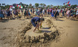 A tourist plays with the sand at the seaside during a pro-Palestinian demonstration that m...