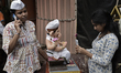 A woman takes a picture of an idol of the Hindu god Ganesha on her mobile phone ahead of t...