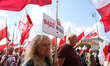 Participants of the White and Red March for the President march through the streets of War...