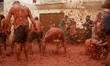 People covered in tomato pulp take part in the 78th 'Tomatina' Festival in Bunol, Spain, o...