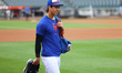 New York Mets starting pitcher Jonah Tong, 21, comes out to the outfield to stretch before...