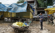 People clean the stalls after the market is hit by flash floods in Islamabad/Anantnag dist...