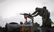 National Guard soldiers shoot the grenade launcher during the fight with pro-russian separ...