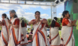 Women dressed in traditional Kerala Kasavu sarees move rhythmically to the tune of melodio...