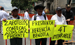 People hold signs in support of the 4T and Mexican President Claudia Sheinbaum at the Zoca...