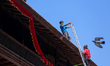 Nepali workers change the sacred clothes at various temples in the premises of Kathmandu D...