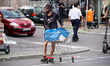 A homeless person walks with his cart on Karl-Marx-Strasse in the neighborhood of Neukoell...