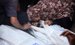 (EDITOR'S NOTE: Image depicts death) A Palestinian woman mourns by the body of a relative...