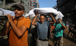 Palestinians carry the shrouded bodies of people killed in Israeli strikes on Gaza City at...