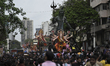 Devotees carry idols of Lord Ganesh, the Hindu god of prosperity, in a procession ahead of...
