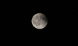 Total lunar eclipse over Europe. A rare blood moon appears rising in the night sky during...