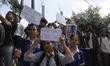 Protestors display placards in defiance during an anti-corruption and anti-social media ba...
