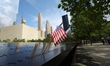 A USA flag is placed on a name on the panel of the North Pool, one of two reflecting pools...