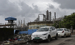 An electric car is parked near an oil refinery in Mumbai, India, on September 12, 2025. 