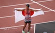 Hayato Katsuki (JAP) drapes in the Japanese flag after winning bronze in the Men's 35km Wa...